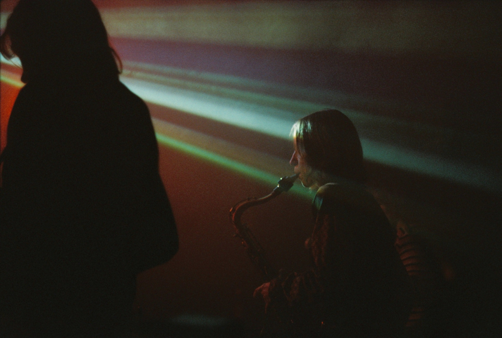 A girl playing saxophone on a concert