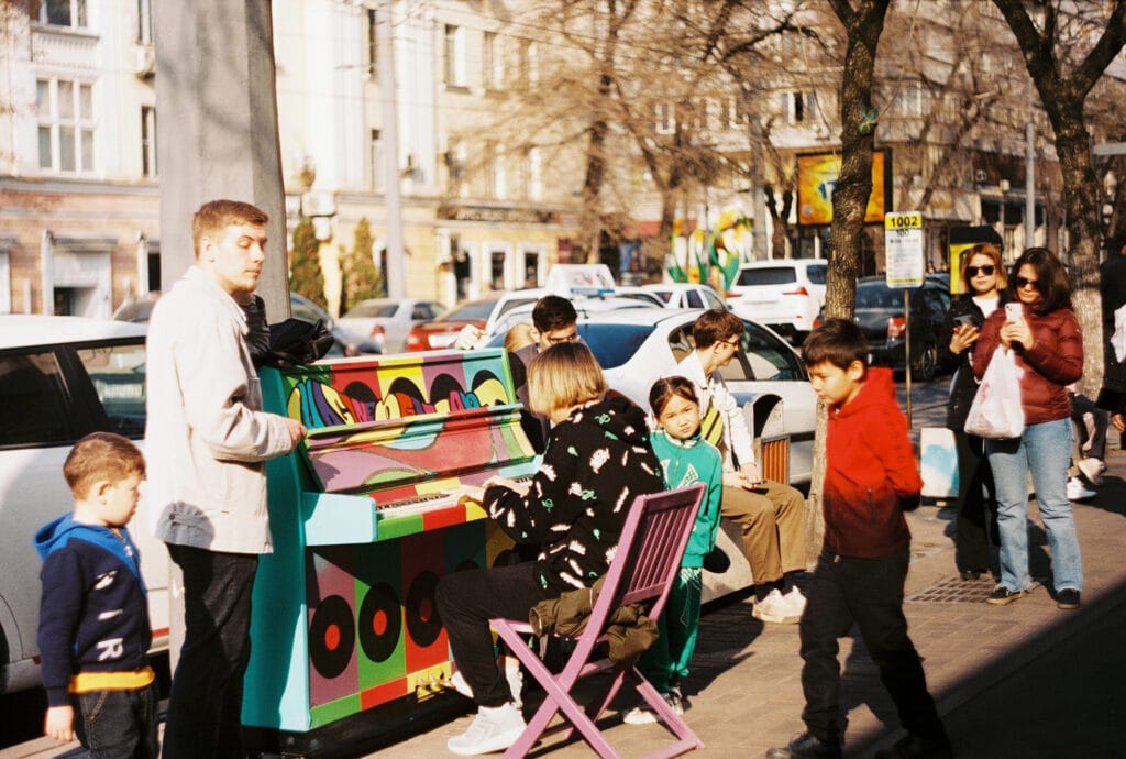 A boy playing piono on a steet in Almaty, Kazakhstan, street photography